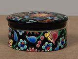 a black box with colorful flowers on it on a table