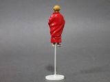 figurine of a man in a red suit on a white stand