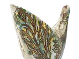 a white vase with a green and blue design on it