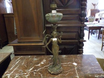 a statue of a woman holding a vase on top of a marble table