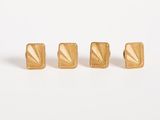 a set of three gold stud earrings on a white background