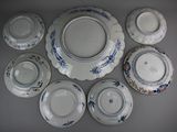 many plates and bowls arranged together on a table