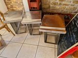 several tables and chairs in a room with a chalk board on the floor