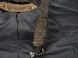 a helmet on the back of a black bag
