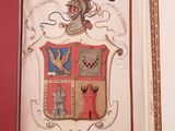 an open book with a picture of a coat of arms on it