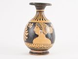 a black and gold vase with an image of a woman on it
