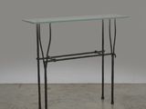 a glass table with a metal frame and a glass top