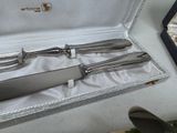 three knives in a case sitting on a table