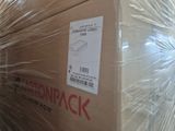 a box that is wrapped in plastic and sitting on a pallet