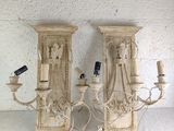 two wall sconces that are attached to the wall