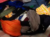 a pile of clothes that is sitting on the floor