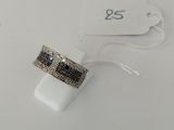 a close up of a ring on a white surface with a price tag