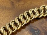 gold chain bracelet on a wooden table on a wooden surface