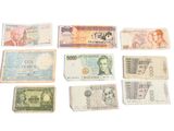 several different types of paper money laid out on a white surface