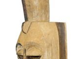 an old wooden sculpture of a man ' s head on a white background