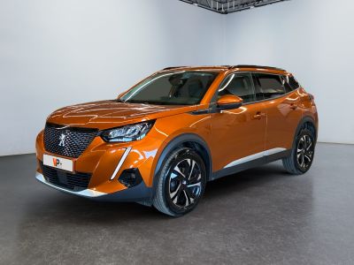 the orange suv is parked in a large room with white walls