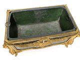 a green and gold box on a white surface
