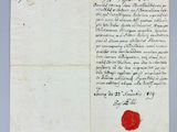 a piece of paper with a red wax stamp on it
