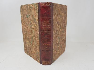 an old book sitting on top of a white surface