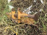 a rusted fire hydrant sitting in the middle of a field