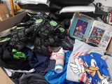 a cardboard box filled with clothing and other items