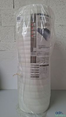 une bouteille d'eau posée sur un plan de travail, enveloppée dans un film plastique