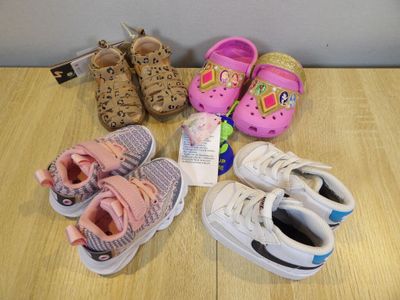 many pairs of shoes that are on the floor