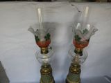 two glass vases with birds on them on a table