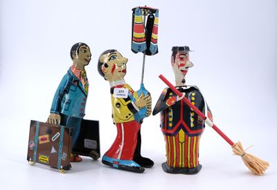 three figurines of men with luggage and a broom