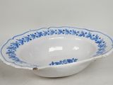 blue and white porcelain bowl with blue flowers on the rim