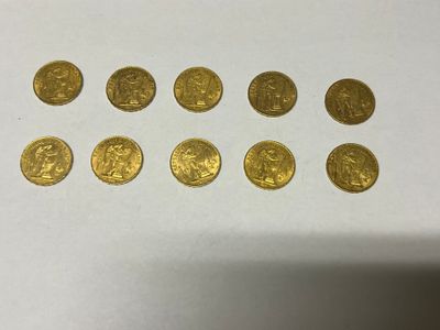 a bunch of gold coins sitting on top of a white table