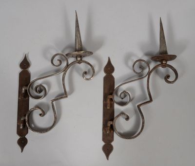 pair of antique wrought iron sconces on a white background