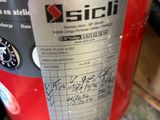 a close up of a red fire extinguisor on a table