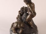 bronze statue of a boy and a dog on a marble base