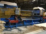 a machine that is working on a piece of wood