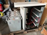 a refrigerator that has a bunch of electrical equipment in it