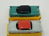 three toy cars sitting on top of each other on a table