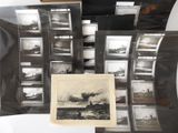 a lot of black and white pictures on a table