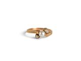 an image of a gold ring with two pearls on it