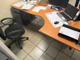 a desk with two computers and a laptop on it