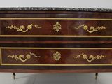 a marble top chest of drawers on a marble top