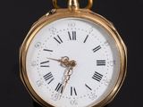 une montre de poche en or avec des chiffres romains sur le cadran