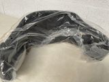 a black object wrapped in plastic sitting on a table