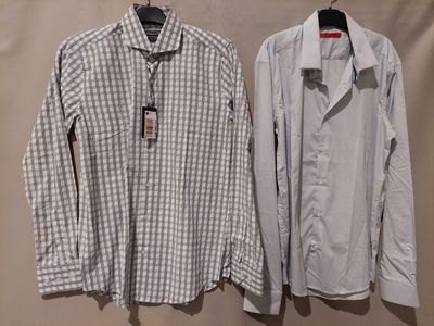 two men ' s shirts hanging on a hanger on a wall