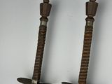 pair of antique wooden swords with metal handles on a white background