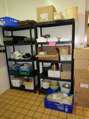 une pièce avec beaucoup de boîtes et de cartons sur les étagères