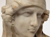 marble bust of a woman wearing a turban and a scarf