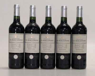 six bottles of wine are lined up in a row on a table