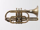an old brass trumpet hanging from the ceiling