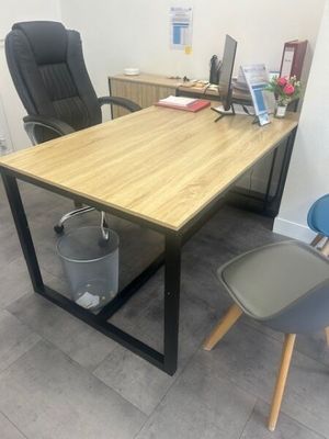 a desk with a chair and a laptop on it